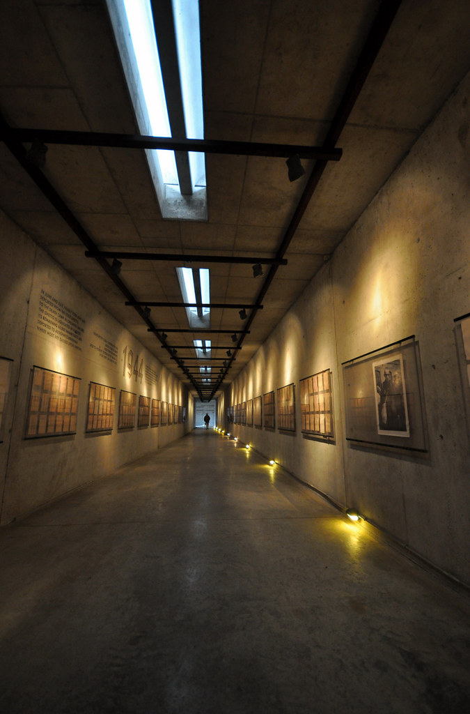 long purposefully lit hallway with the pictures of those deported.  